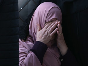 caption: A Palestinian woman mourns after an Israeli airstrike at the Rafah refugee camp, in the southern Gaza Strip on Tuesday.