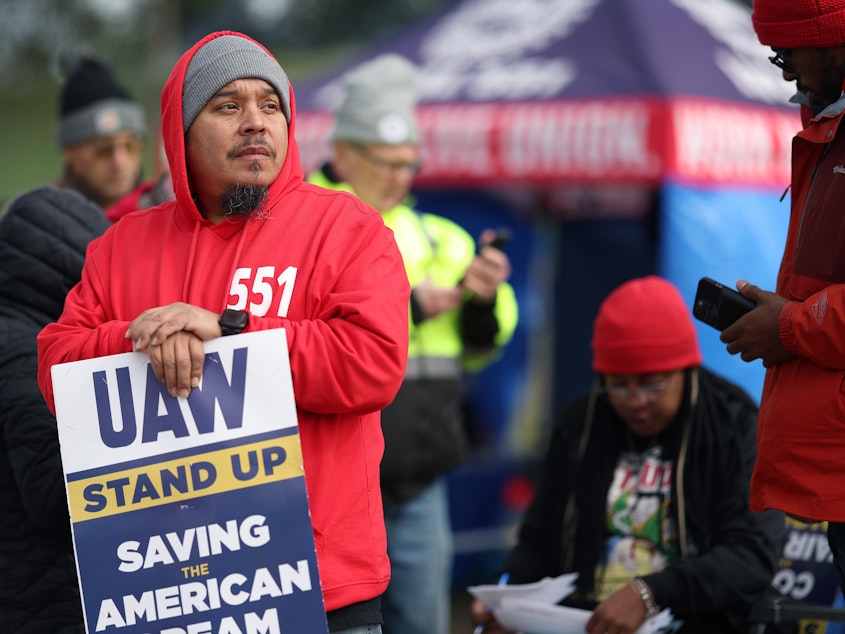 caption: Workers picket outside a Ford plant in Chicago on Oct. 10, 2023. The U.S. created 150,000 jobs in October, marking a slowdown from the previous month, partly as a result of the UAW strikes.