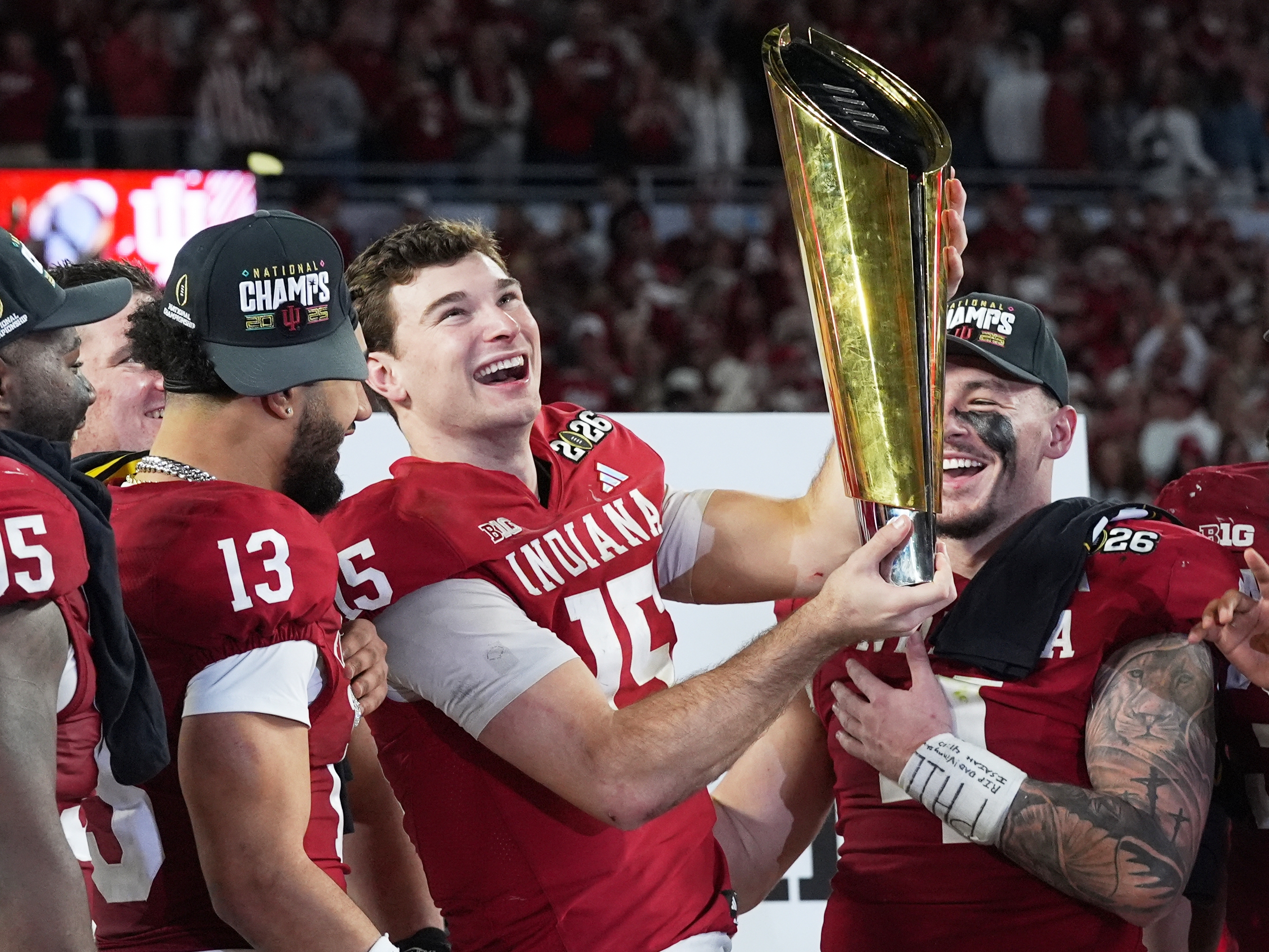 caption: Indiana quarterback Fernando Mendoza holds the trophy after their win against Miami in the College Football Playoff national championship game, Monday, Jan. 19, 2026, in Miami Gardens, Fla.