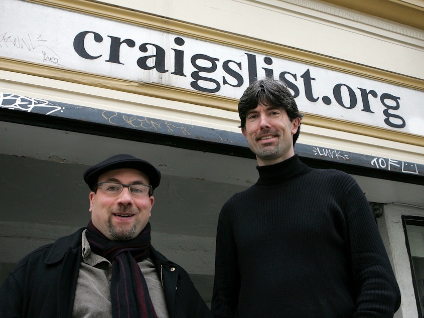caption: Craigslist founder Craig Newmark (L) and CEO Jim Buckmaster pose in front of the Craigslist office March 21, 2006 in San Francisco. The site has become a behemoth but changed little aesthetically.