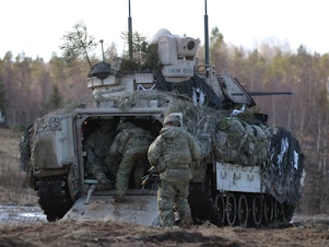 caption: U.S. soldiers take part in a joint military combat exercise with Estonian soldiers in 2017 near Tapa, Estonia. The U.S. is readying 8,500 troops to possibly deploy to Eastern Europe.