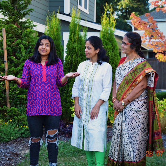 caption: The two generations of Ritika's family watching how she leads her life. Ritika stands with her mom Anitha (middle) and her grandma Vasantha (right).
