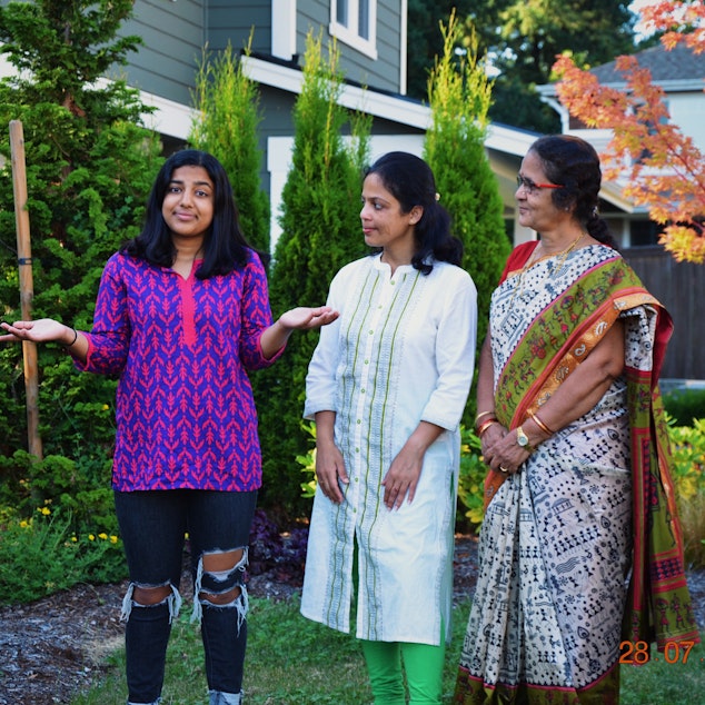 caption: The two generations of Ritika's family watching how she leads her life. Ritika stands with her mom Anitha (middle) and her grandma Vasantha (right).