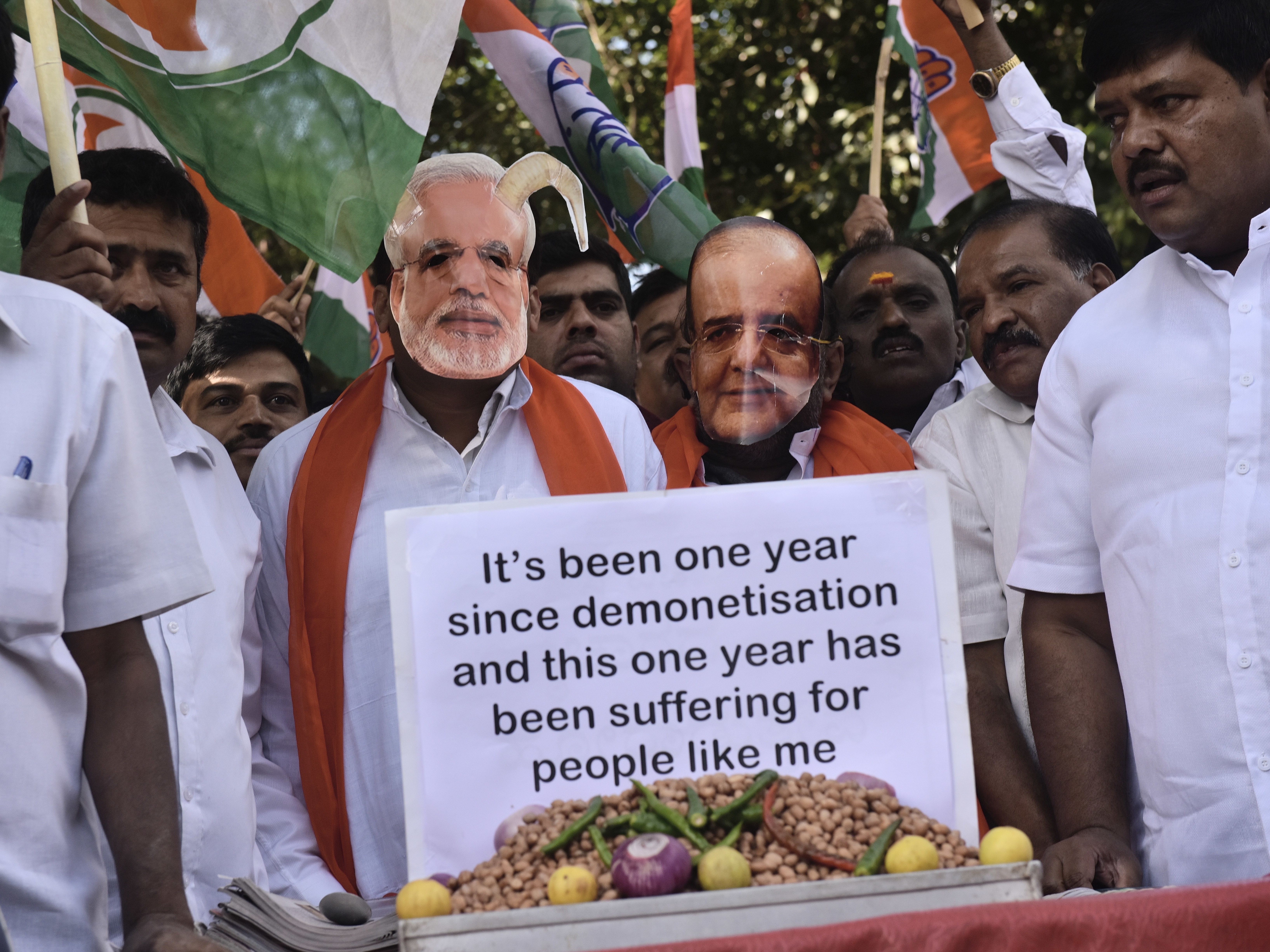 BENGALURU, INDIA - NOVEMBER 8: Karnataka Pradesh Congress Committee member sports a caricatured mask of the prime minister of India Narendra Modi and Finance Minister Arun Jaitley as they staged a demonstration on the first anniversary of demonitization on November 8, 2017 in Bengaluru, India.