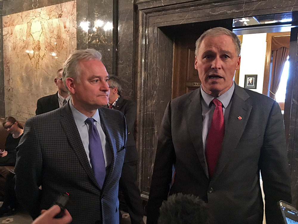 caption: Washington state Sen. Reuven Carlyle, pictured on the left of Gov. Jay Inslee in this file photo, is sponsoring a sweeping data privacy bill this year