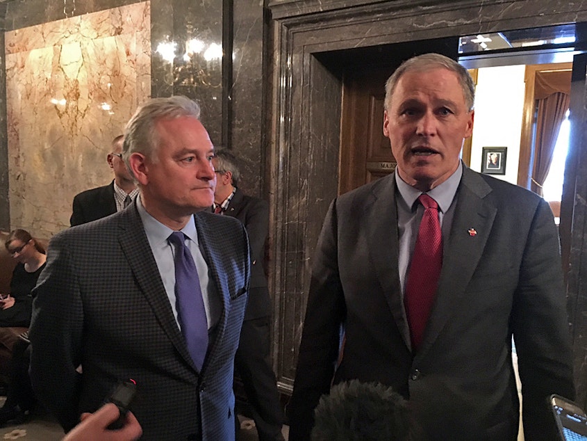 caption: Washington state Sen. Reuven Carlyle, pictured on the left of Gov. Jay Inslee in this file photo, is sponsoring a sweeping data privacy bill this year