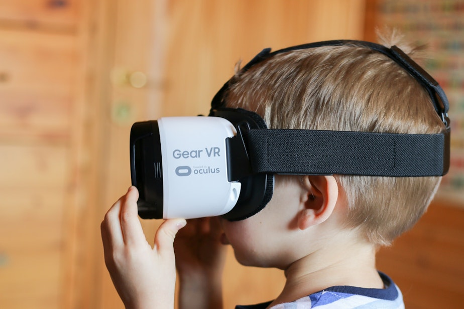 caption: A young tyke uses a VR headset.