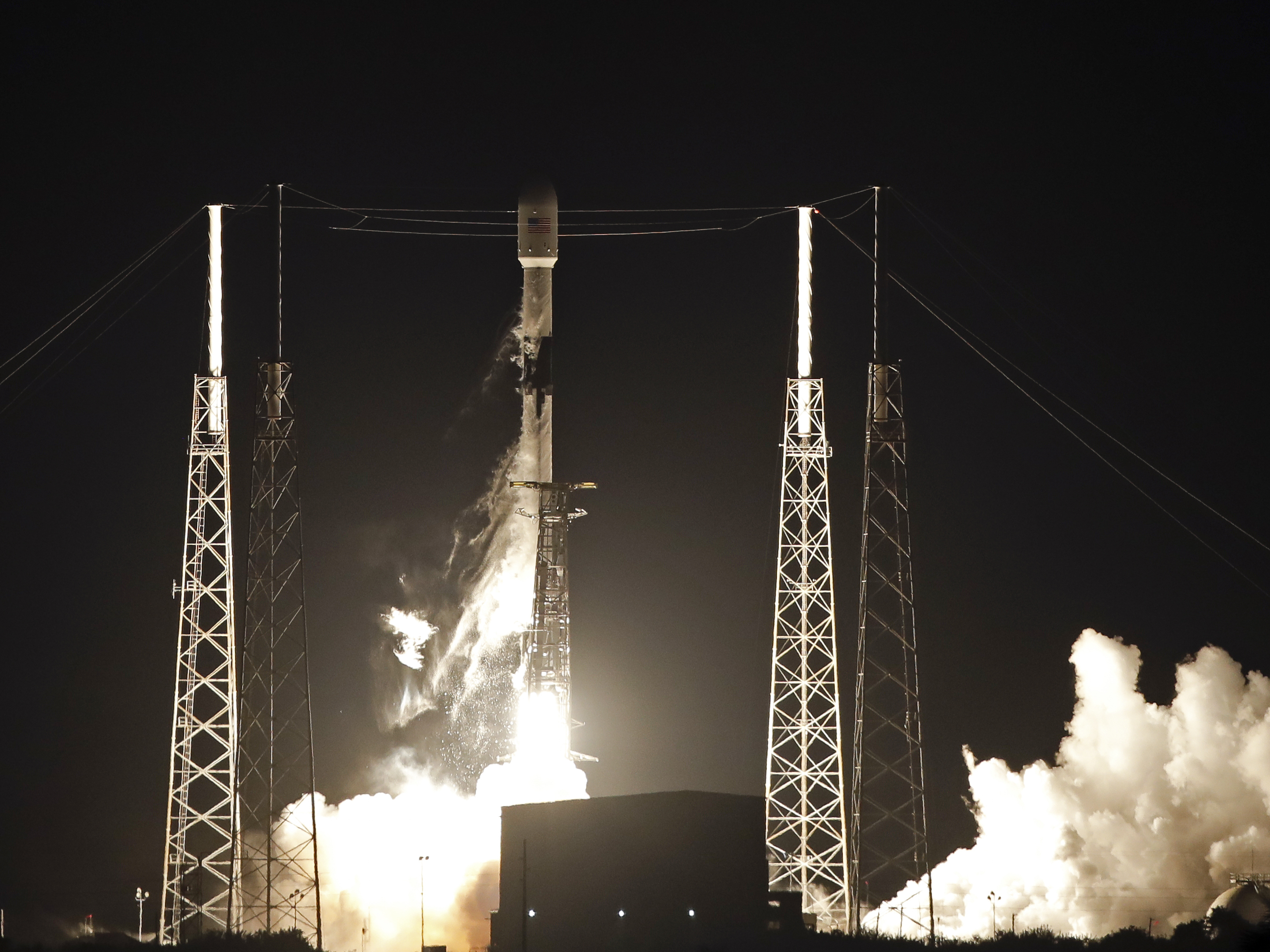 caption: A Falcon 9 rocket carried 60 satellites for SpaceX's Starlink broadband network into space last month.