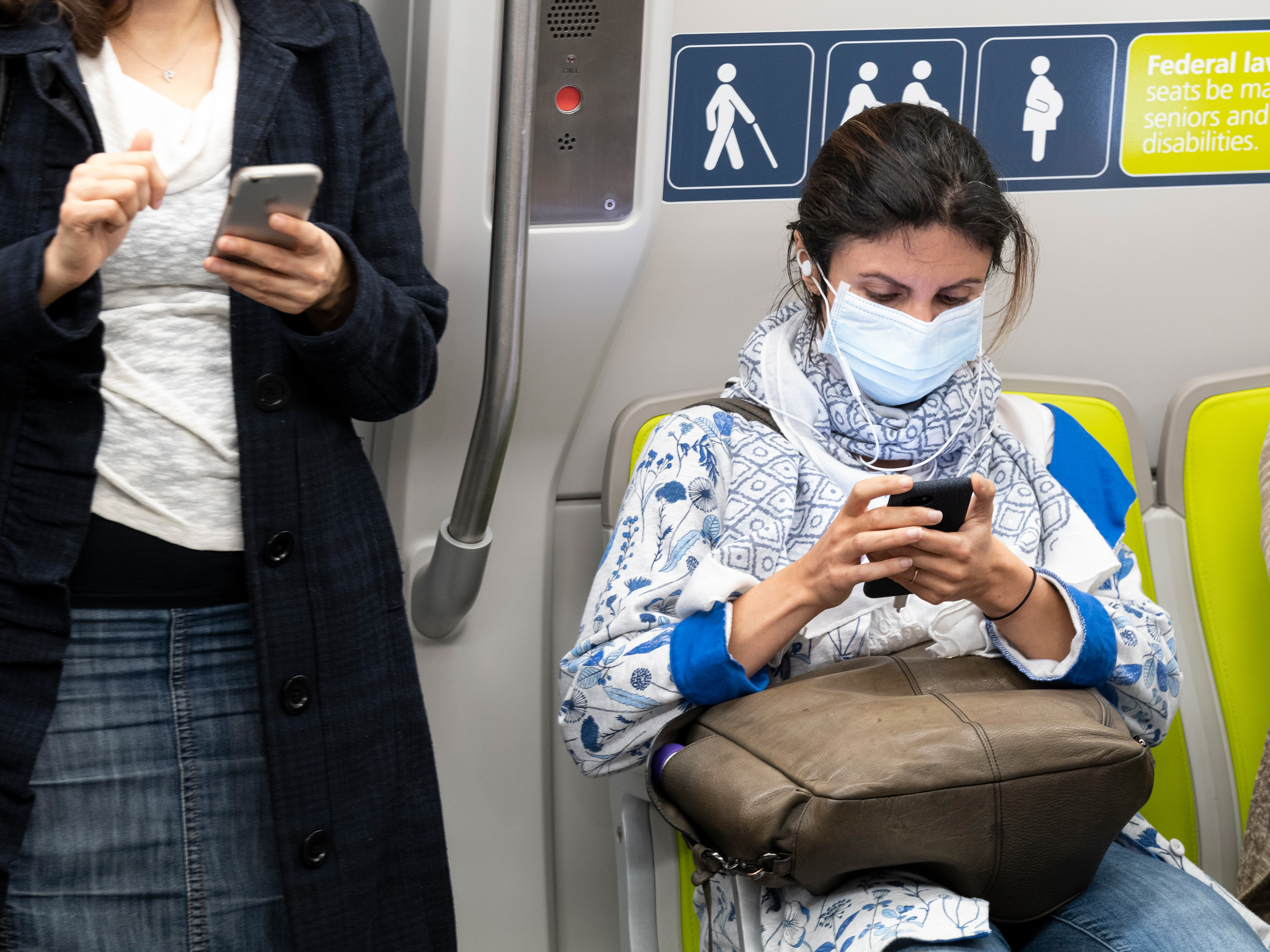 caption: Health officials have identified what could be the first U.S. case of the novel coronavirus spreading within the general population. But a hospital says the diagnosis was delayed for days. Here, a passenger wears a face mask on a train in San Francisco Wednesday.
