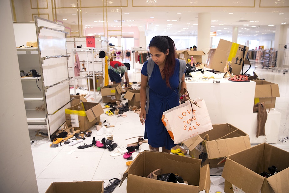 caption: Shivangi Mishra looks through boxes of shoes at Forever 21 on Monday, July 22, 2019, at Northgate Mall in Seattle. 