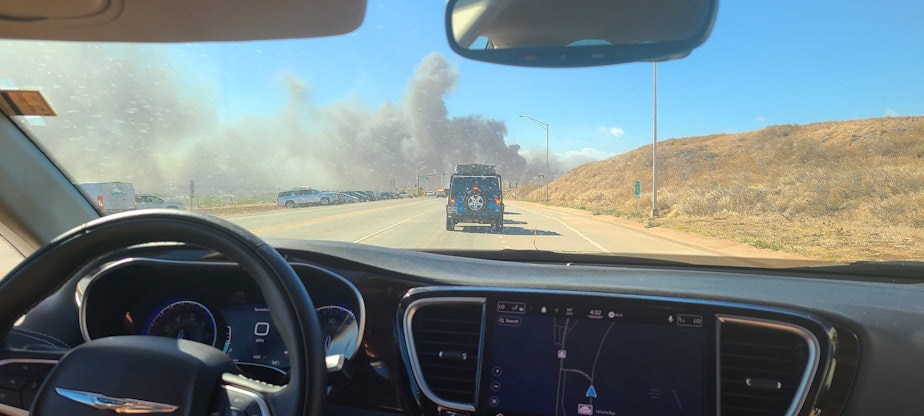 caption: After the Vogt family toured sites Maui Monday, they headed back to their resort – and traffic stopped. Flames jumped the highway, said mom, Kara Vogt.