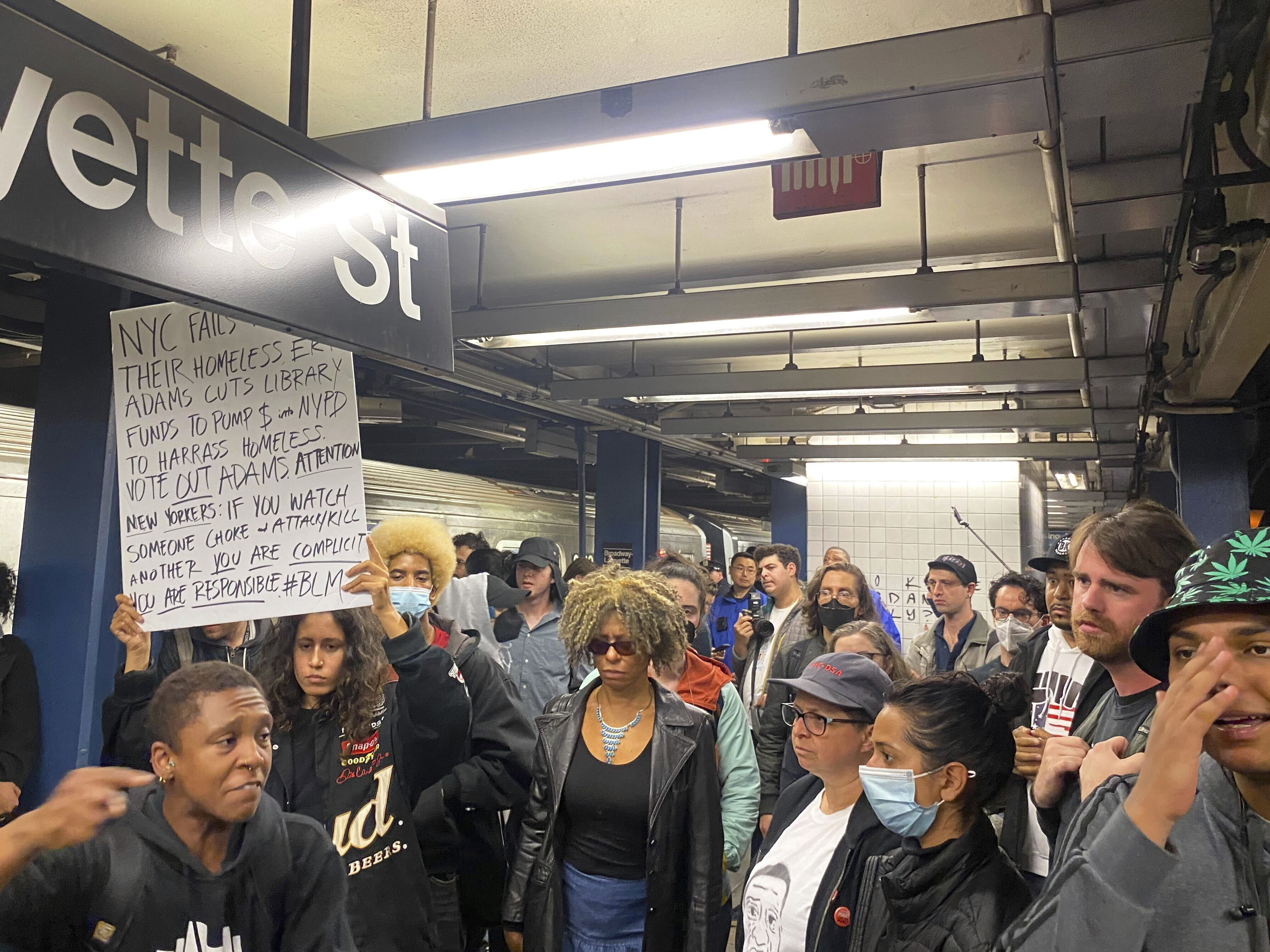 caption: Protesters march through the Broadway-Lafayette subway station to protest the death of Jordan Neely on Wednesday in New York.