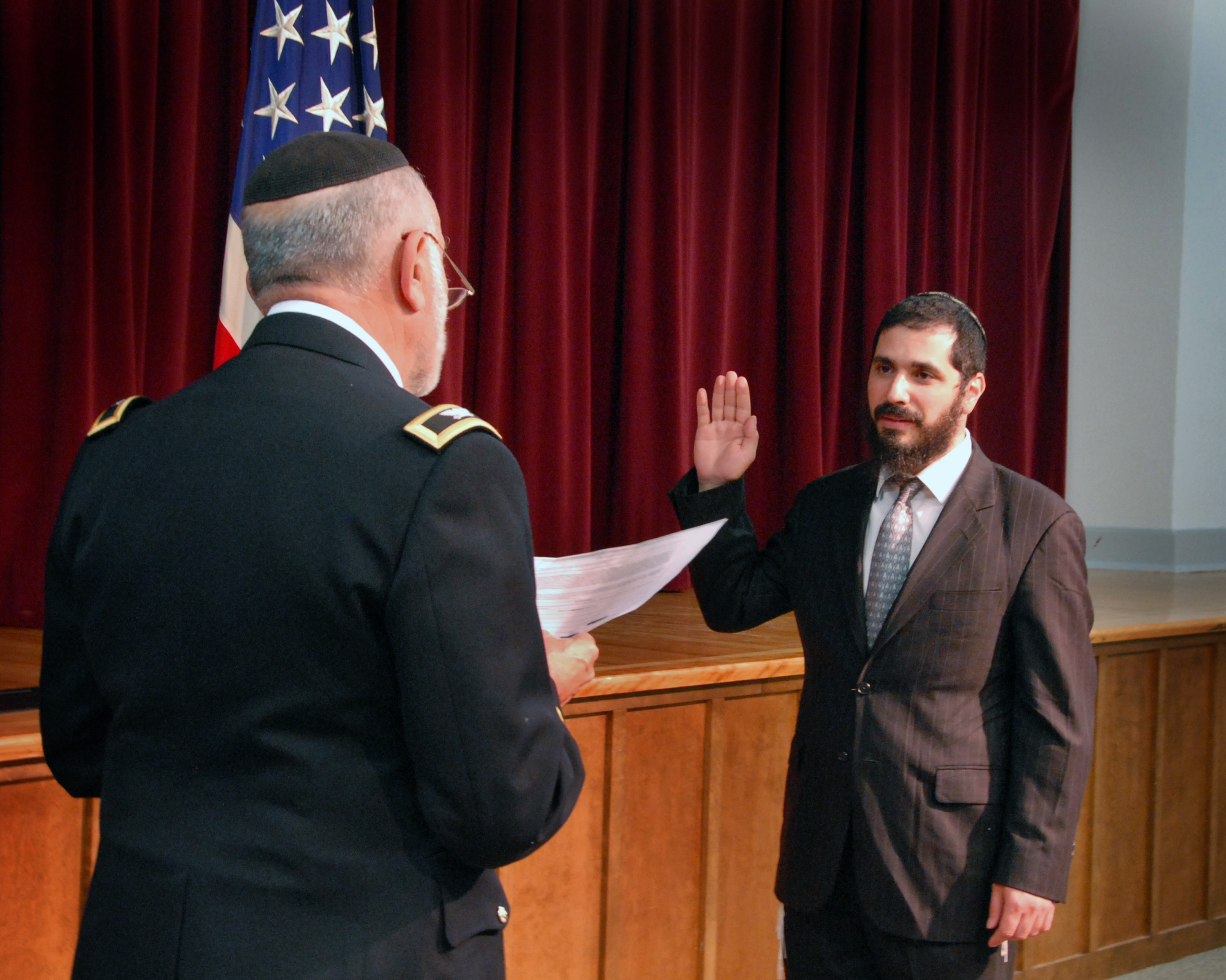 caption: Rabbie Elie Estrin is sworn into the U.S. Airforce on September 10, 2014.