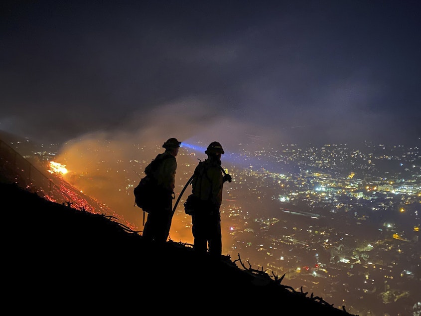 caption: Firefighters battle a brush fire last week in Santa Barbara, Calif. Climate-driven droughts make large, destructive fires more likely around the world. Scientists warn that humans are on track to cause catastrophic global warming this century.