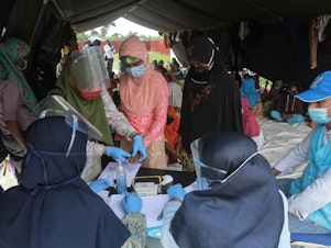 caption: Rohingya refugees at a work training center in Aceh Province in Indonesia. Dr. Paul Spiegel is looking at the data that has been collected on refugees and other vulnerable populations. It's far from complete, he says, but he's been surprised by the impact of COVID among Rohingya.