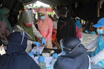caption: Rohingya refugees at a work training center in Aceh Province in Indonesia. Dr. Paul Spiegel is looking at the data that has been collected on refugees and other vulnerable populations. It's far from complete, he says, but he's been surprised by the impact of COVID among Rohingya.