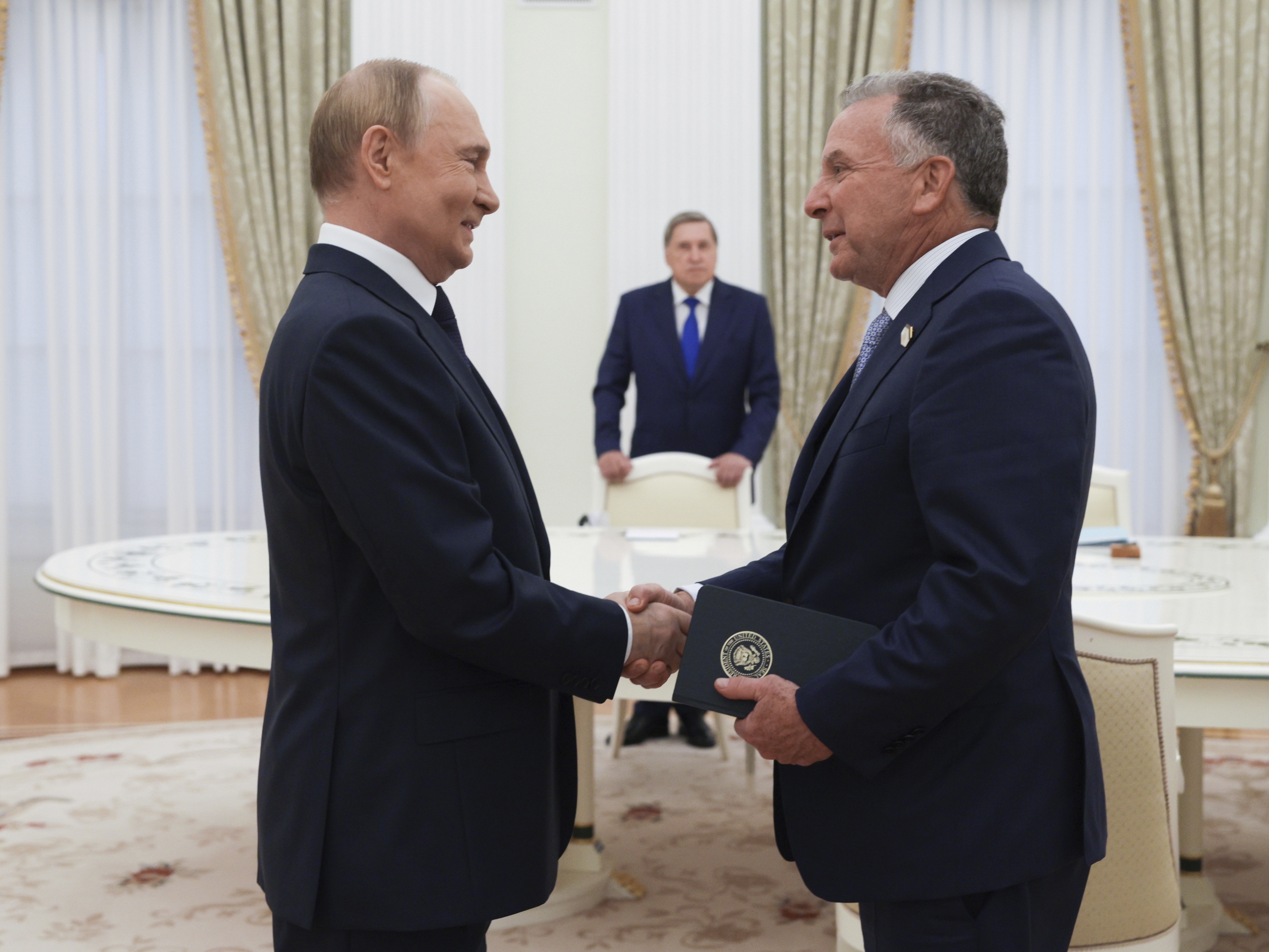 caption: Russian President Vladimir Putin (left) and U.S. special envoy Steve Witkoff shake hands during their meeting in Moscow, Wednesday.