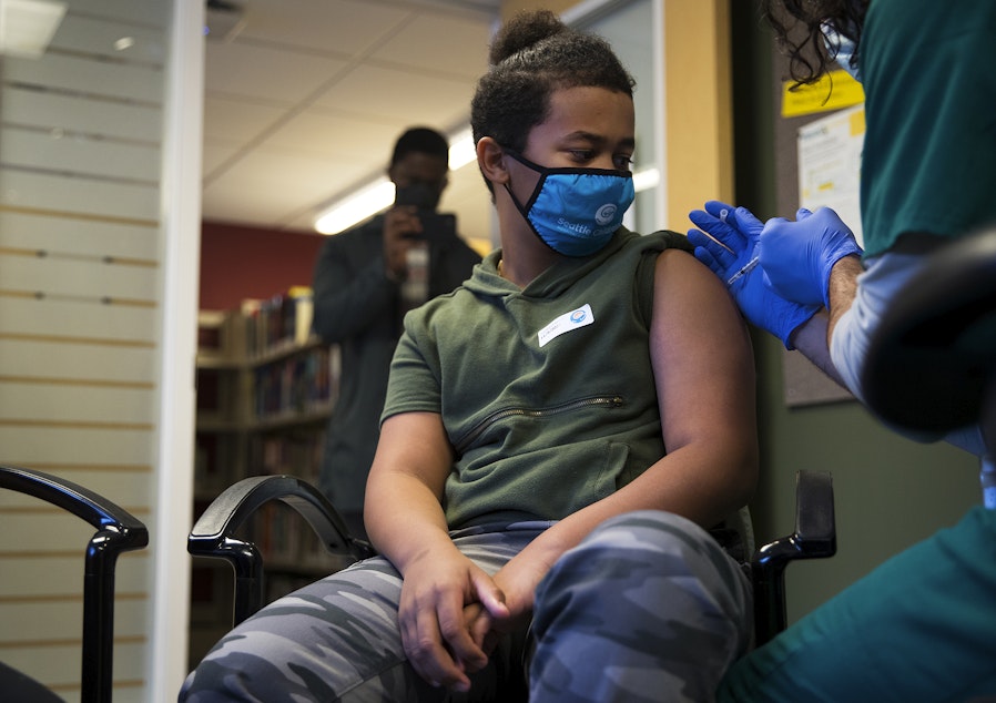 caption: Isaiah Williams, 10, receives a dose of the Covid-19 vaccine on Tuesday, November 9, 2021, at Seattle Children's Hospital in Seattle.