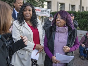 caption: Wandrea "Shaye" Moss, second from left, and her mother Ruby Freeman, right, leave after speaking with reporters outside federal court, Friday, Dec. 15, 2023, in Washington. A jury awarded $148 million in damages on Friday to the two former Georgia election workers who sued Rudy Giuliani for defamation over lies he said about them in 2020 that upended their lives with racist threats and harassment.