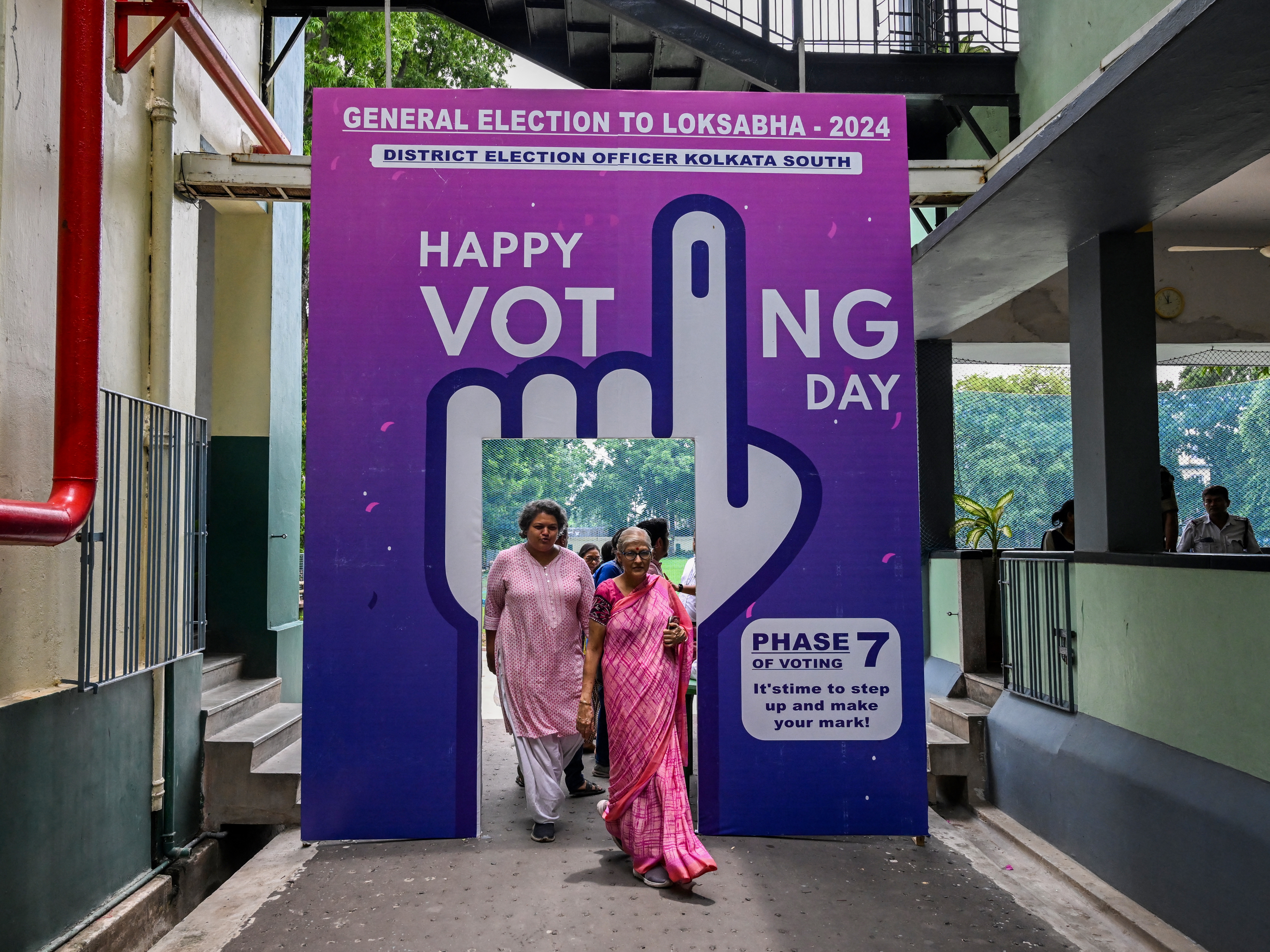 caption: Voters leave after casting their ballot at a polling station in the final phase of voting in India's general election, in Kolkata on June 1, 2024. Artificial intelligence tools were used to create memes and images about political rivals in India and elsewhere around the world.