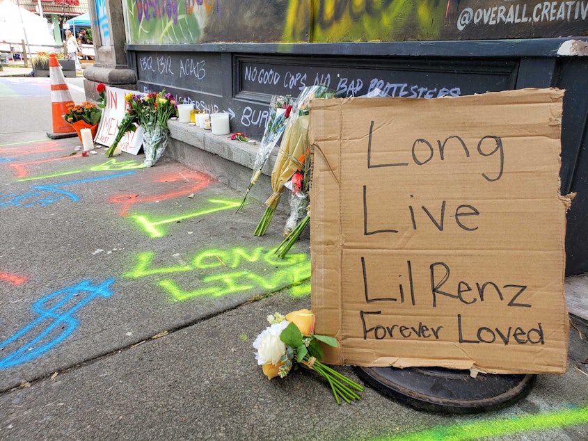 caption: People brought flowers, candles and messages to a memorial at 10th and Pine Streets outside Oddfellows Hall Saturday. An overnight shooting killed a man and critically wounded another inside the Capitol Hill Organized Protest area. 