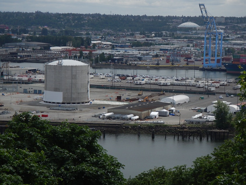 caption: Puget Sound Energy's liquid natural gas tank (foreground), shown in 2019, is about as tall as the Tacoma Dome (background).