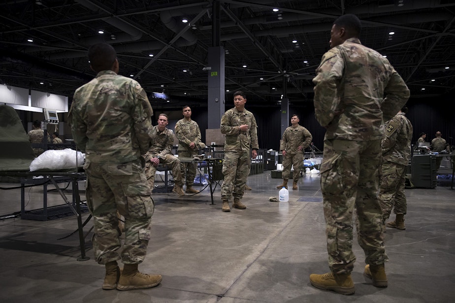 caption: U.S. Army soldiers from the 627th Army Hospital from Fort Carson, Colorado, as well as from Joint Base Lewis-McChord set up a 250-bed military field hospital for non COVID-19 patients on Tuesday, March 31, 2020, at the CenturyLink Field Event Center in Seattle.
