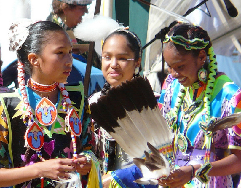 caption: Friends celebrate at the 25th Annual Seafair Indian Days Pow Wow at the Daybreak Star Cultural Center at Discovery Park, Seattle, in July 2010.