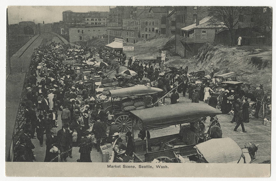 caption: Market vendors gathering on Pike Place, ca. 1907.