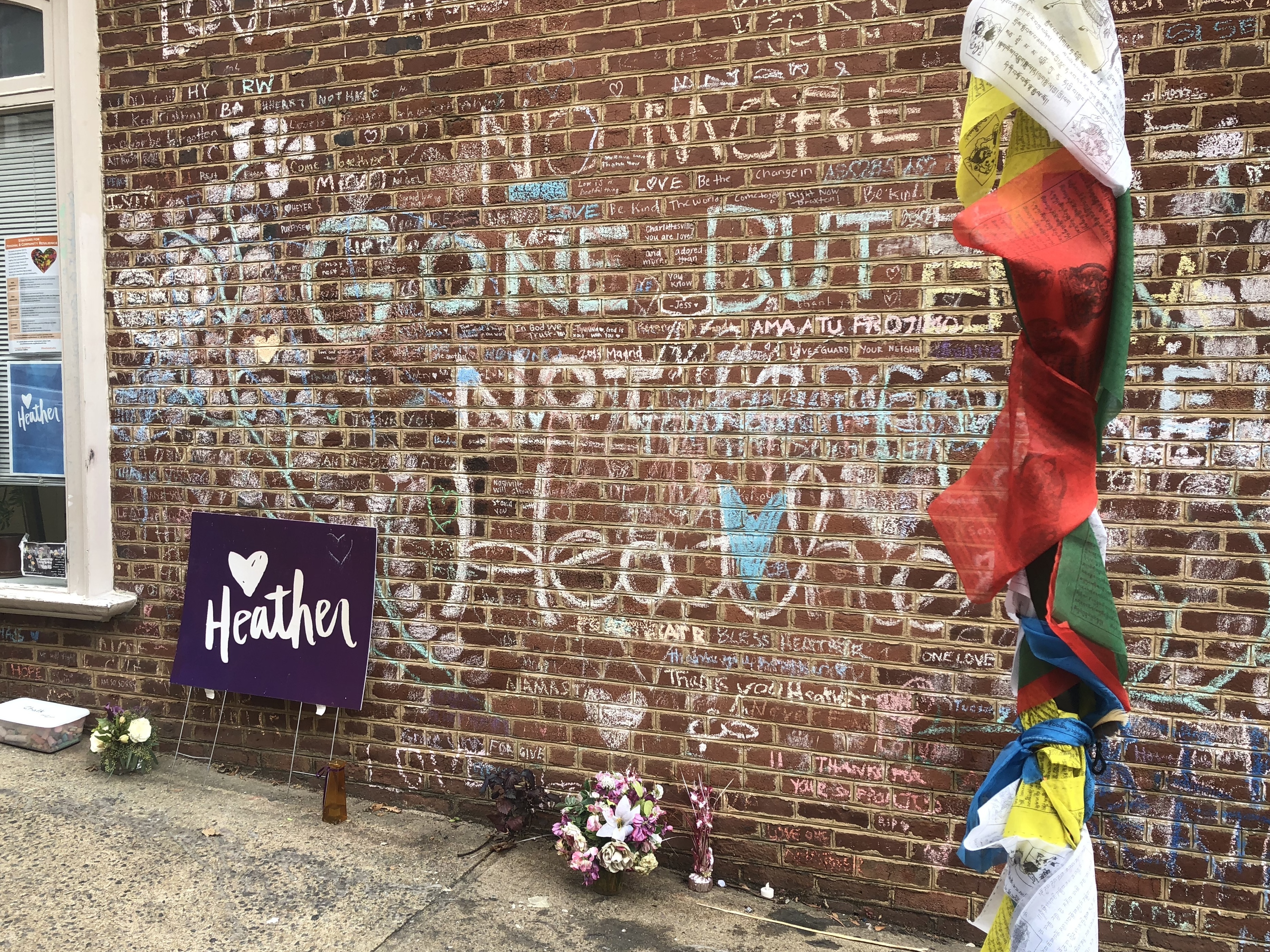 caption: A makeshift memorial on the street where Heather Heyer was killed when a car rammed into a crowd during a white supremacist rally in 2017.