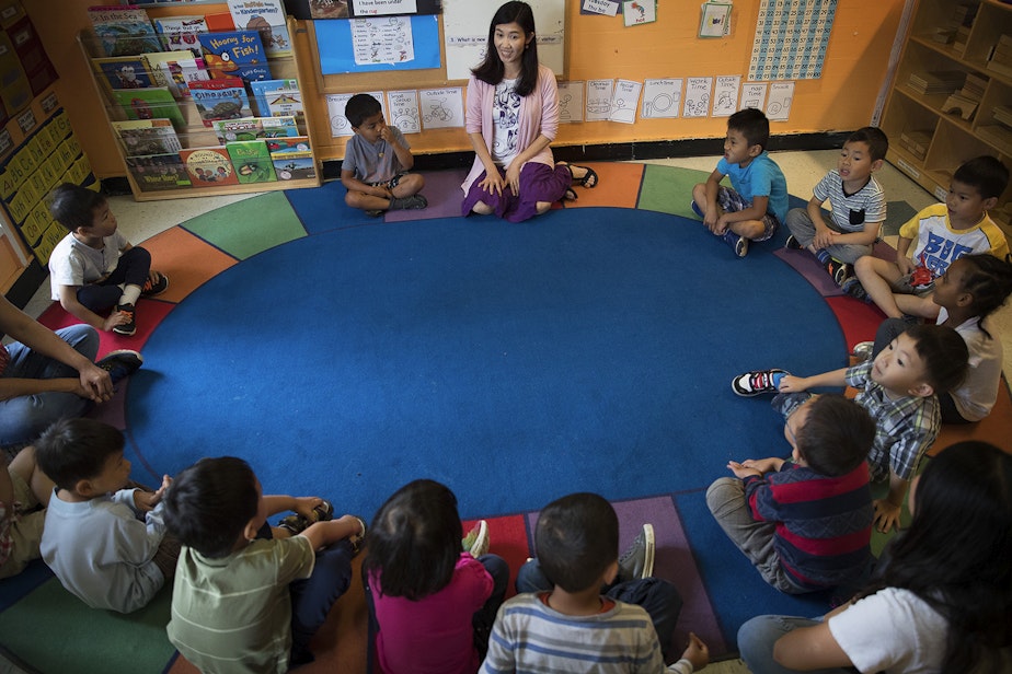 caption: Seattle Preschool Program teacher Hien Do, center, sits in a circle with her students on Wednesday, June 28, 2017, at the ReWA Early Learning Center at Beacon, in Seattle, Washington. 