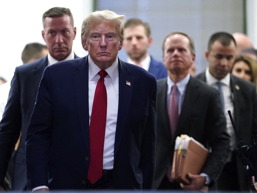 caption: Former President Donald Trump departs for a break during his civil fraud trial in New York City on Thursday.