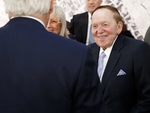 caption: Sheldon Adelson, with his wife, Miriam, talks with then-Secretary of State Rex Tillerson before a 2017 speech by President Trump at the Israel Museum in Jerusalem.