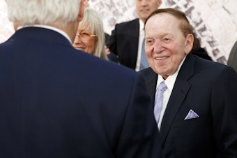 caption: Sheldon Adelson, with his wife, Miriam, talks with then-Secretary of State Rex Tillerson before a 2017 speech by President Trump at the Israel Museum in Jerusalem.