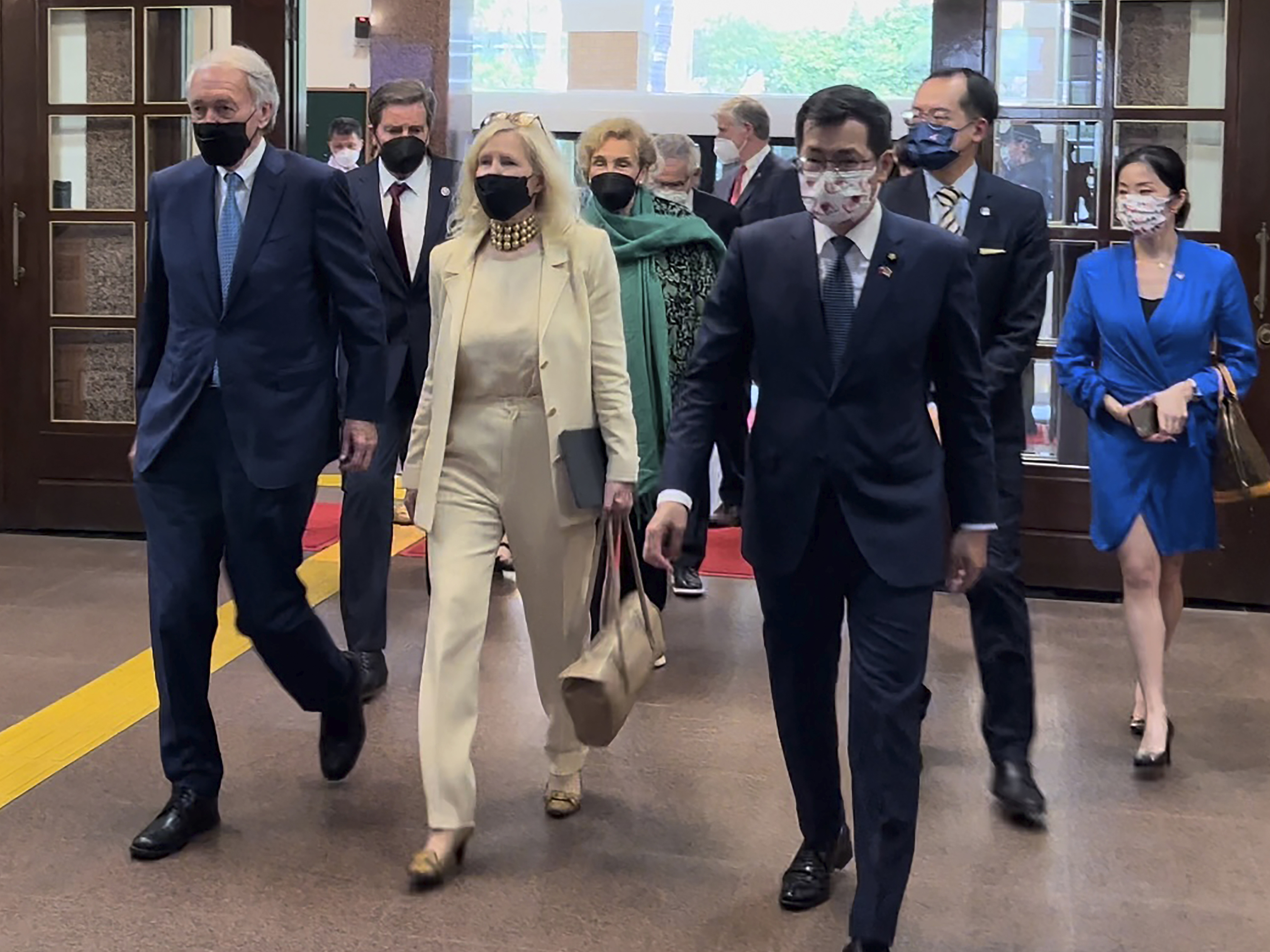 caption: U.S. Democrat Sen. Ed Markey of Massachusetts, left, and Democratic House member John Garamendi of California, second left, back, arrive with their wives at the parliament building in Taipei, on Aug. 15, 2022.