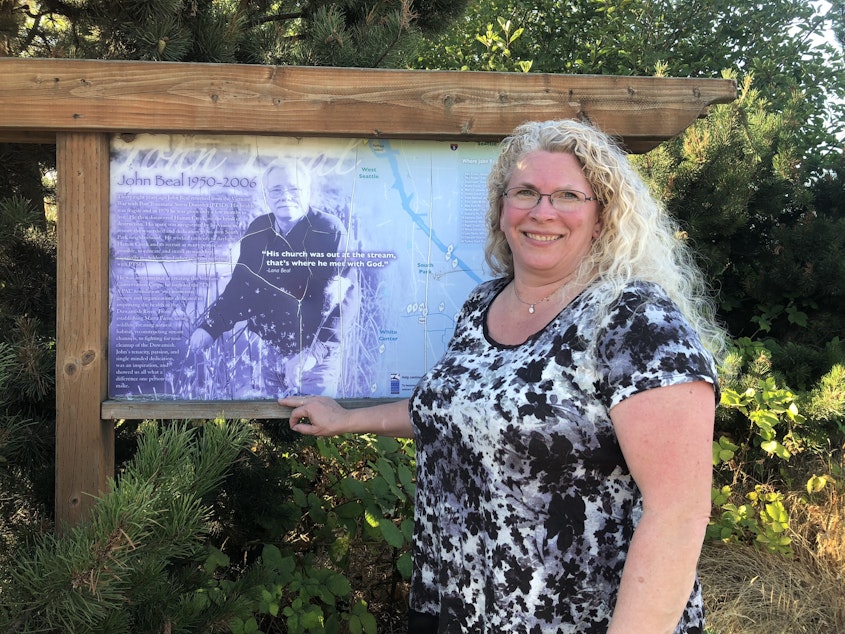 caption: Liana Beal with a tribute to her father, John Beal, at Hamm Creek. "He didn't want the cleanup of the stream and the river to die with him."