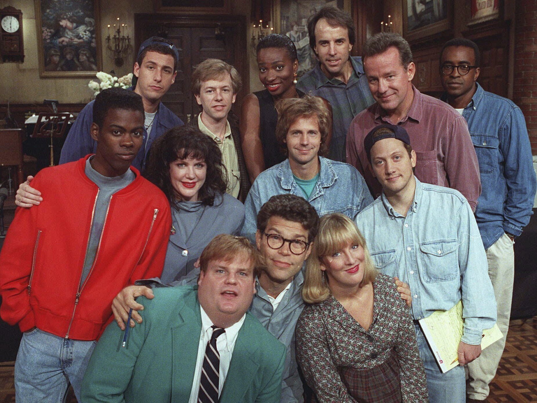 caption: Saturday Night Live is marking its 50th year with a weeklong celebration, including a blockbuster homecoming concert and a three-hour primetime special. Above, <em>SNL</em> cast members pose on the show's set in September 1992. Front row, from left: Chris Farley, Al Franken and Melanie Hutsell. Middle row, from left: Chris Rock, Julia Sweeney, Dana Carvey and Rob Schneider. Back row, from left: Adam Sandler, David Spade, Ellen Cleghorne, Kevin Nealon, Phil Hartman and Tim Meadows.
