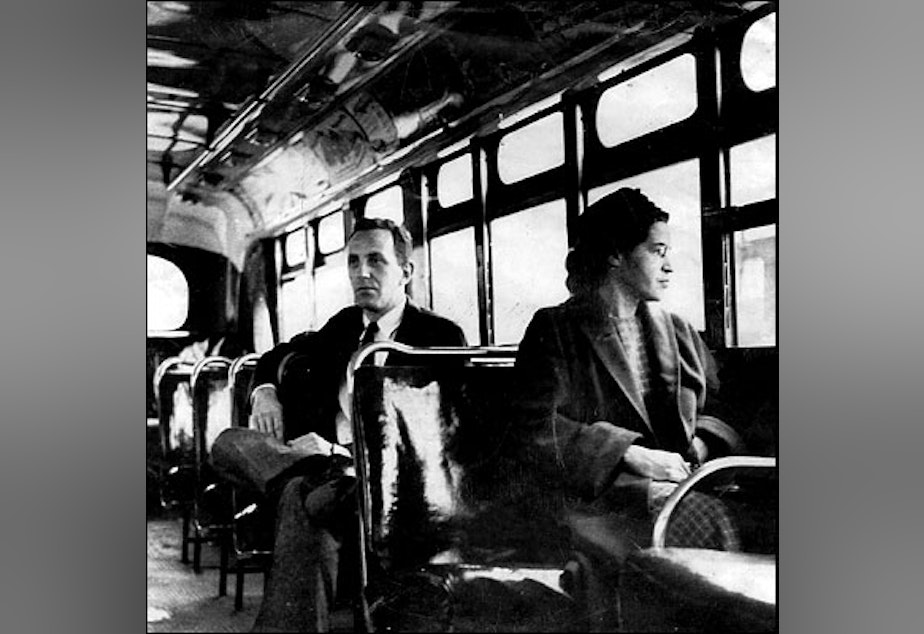 caption: Rosa Parks on a Montgomery bus on December 21, 1956, the day Montgomery's public transportation system was legally integrated.