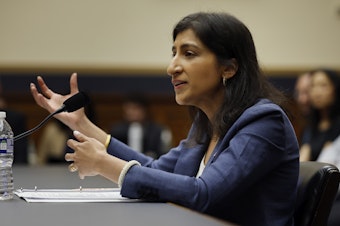 caption: Federal Trade Commission Chair Lina Khan is leading a sweeping lawsuit against Amazon for allegedly abusing its market dominance to stifle competition.