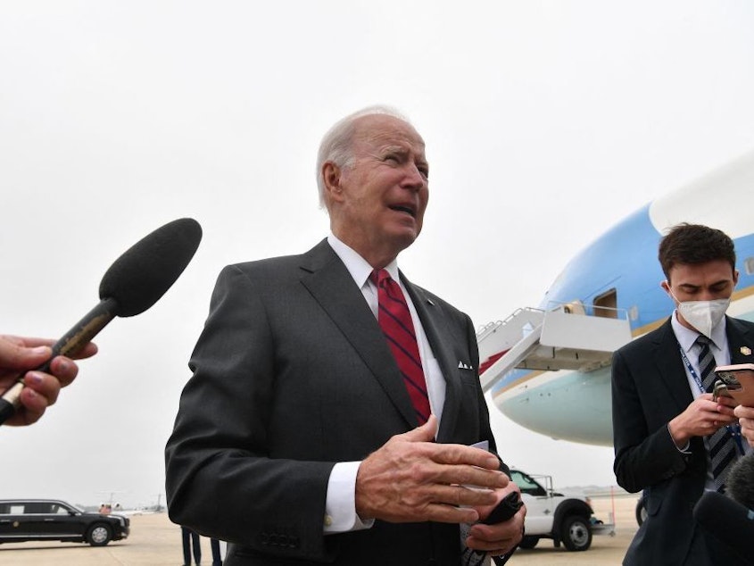 caption: President Biden speaks to members of the press Tuesday prior to boarding Air Force One at Joint Base Andrews in Maryland.