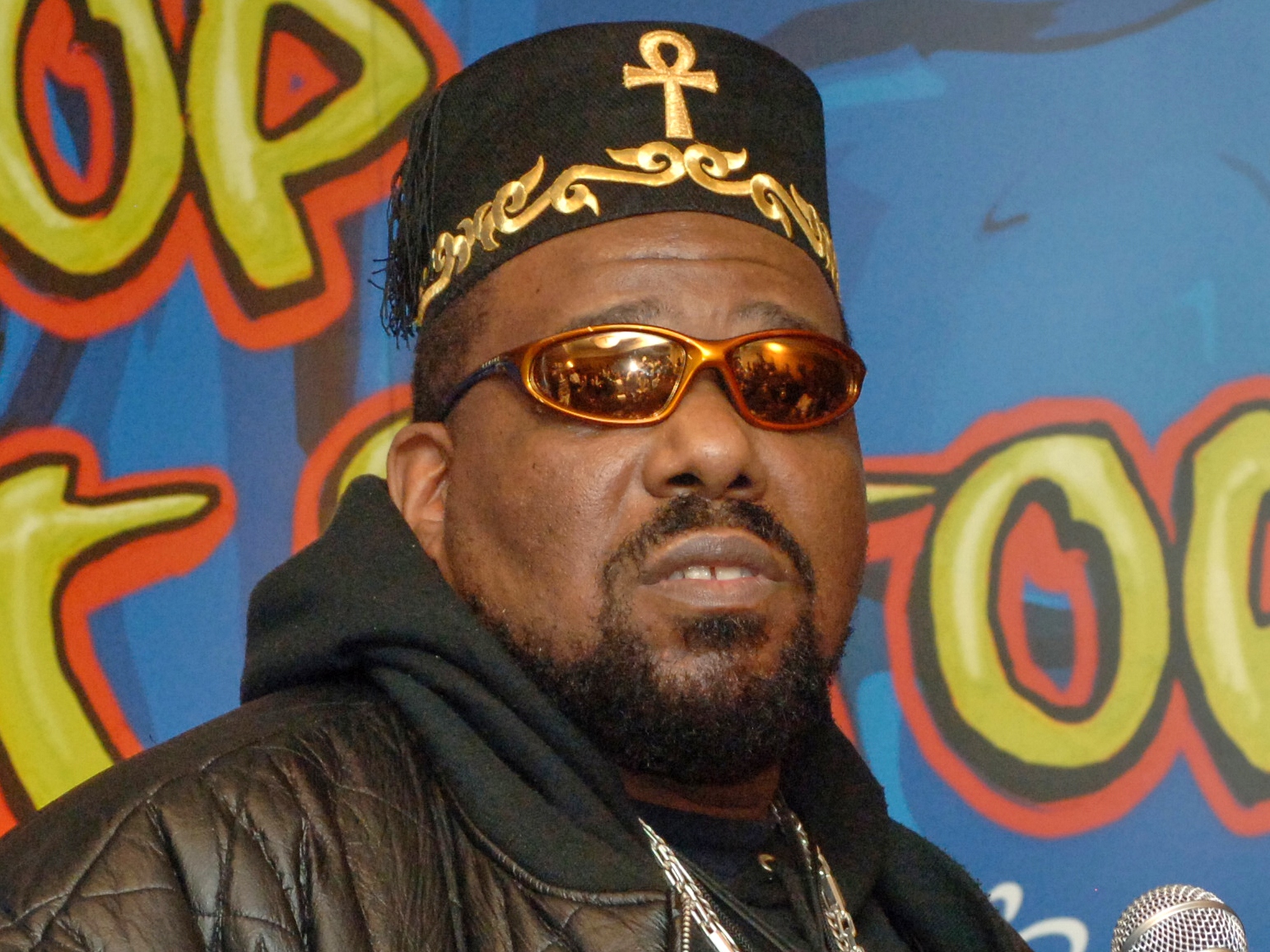 caption: FILE - Hip hop DJ pioneer Afrika Bambaataa speaks at a news conference in New York on Feb. 28, 2006.
