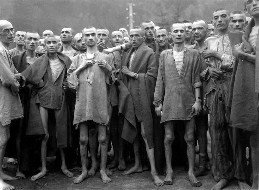 caption: Starving prisoners in Mauthausen camp liberated on 5 May 1945.
