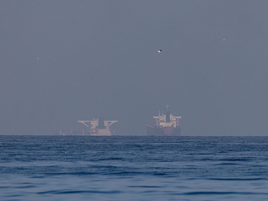 caption: Commercial vessels are seen in the Gulf, near the Strait of Hormuz, in northern Ras al Khaimah, United Arab Emirates, on Sunday.
