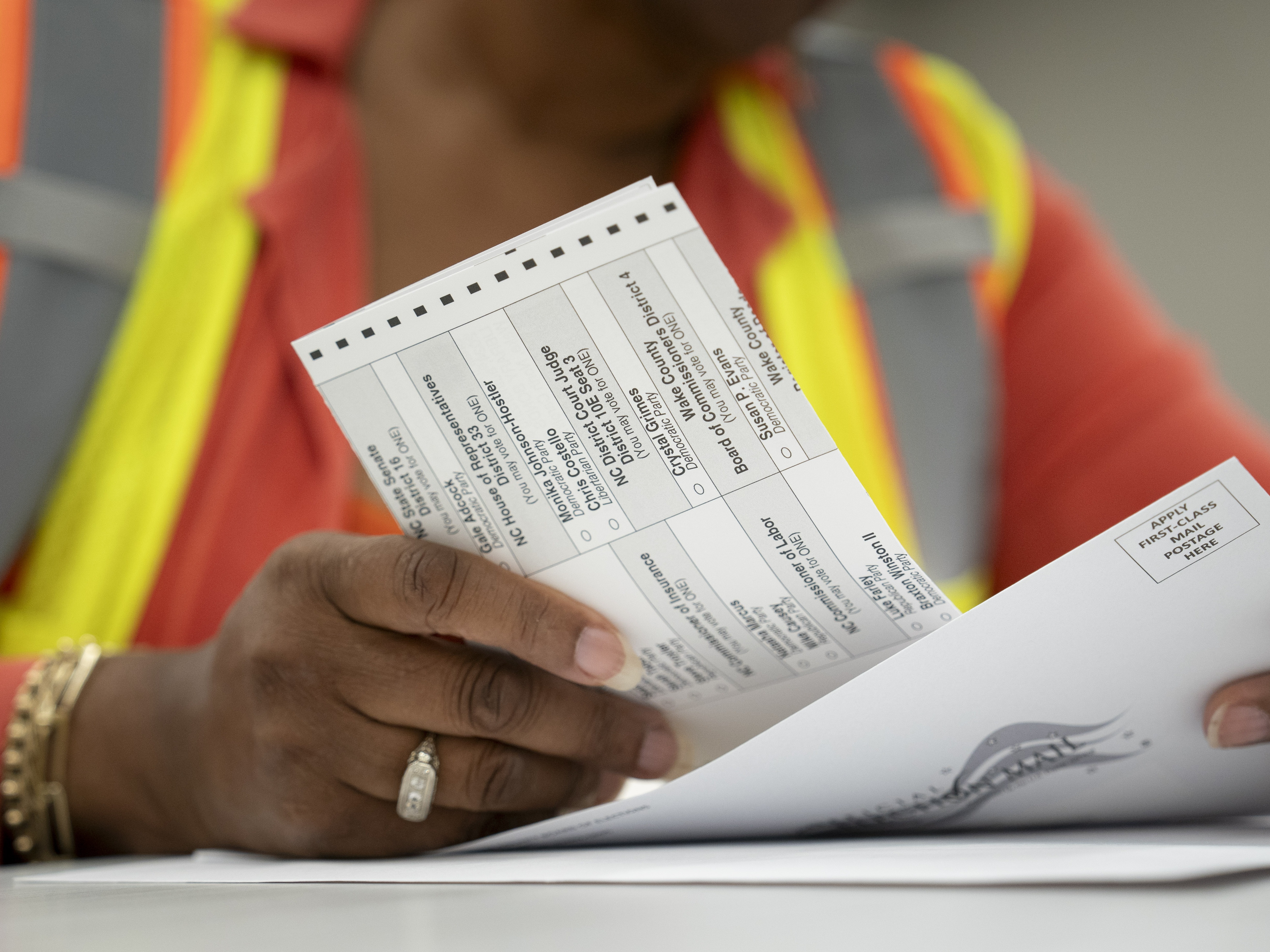 caption: Absentee ballots are prepared to be mailed at the Wake County Board of Elections on Sept. 17 in Raleigh, N.C.