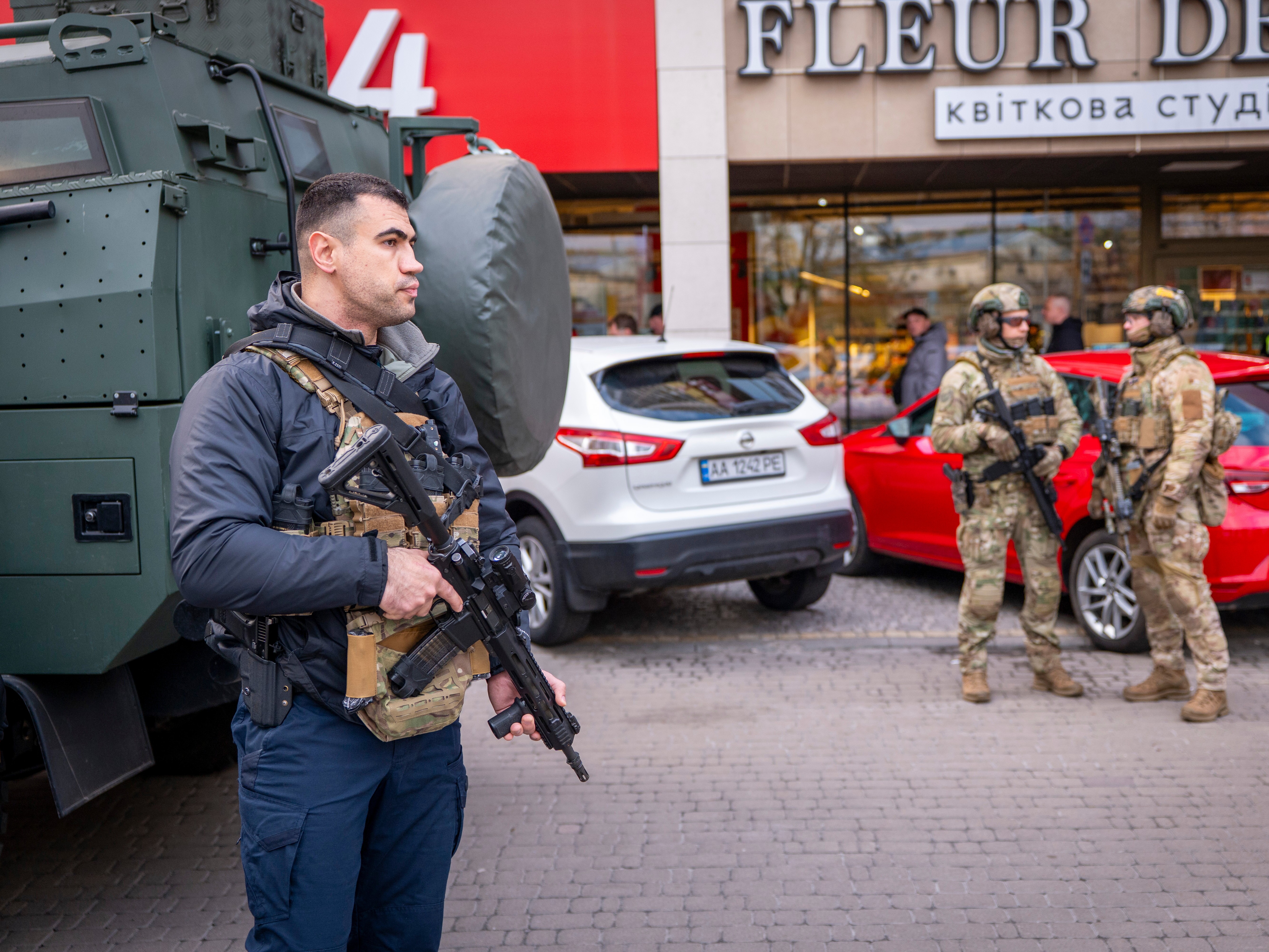 caption: Police officers are seen at the site where a gunman killed at least six people in the streets before being shot dead by police, in Kyiv, Ukraine, Saturday, April 18, 2026.