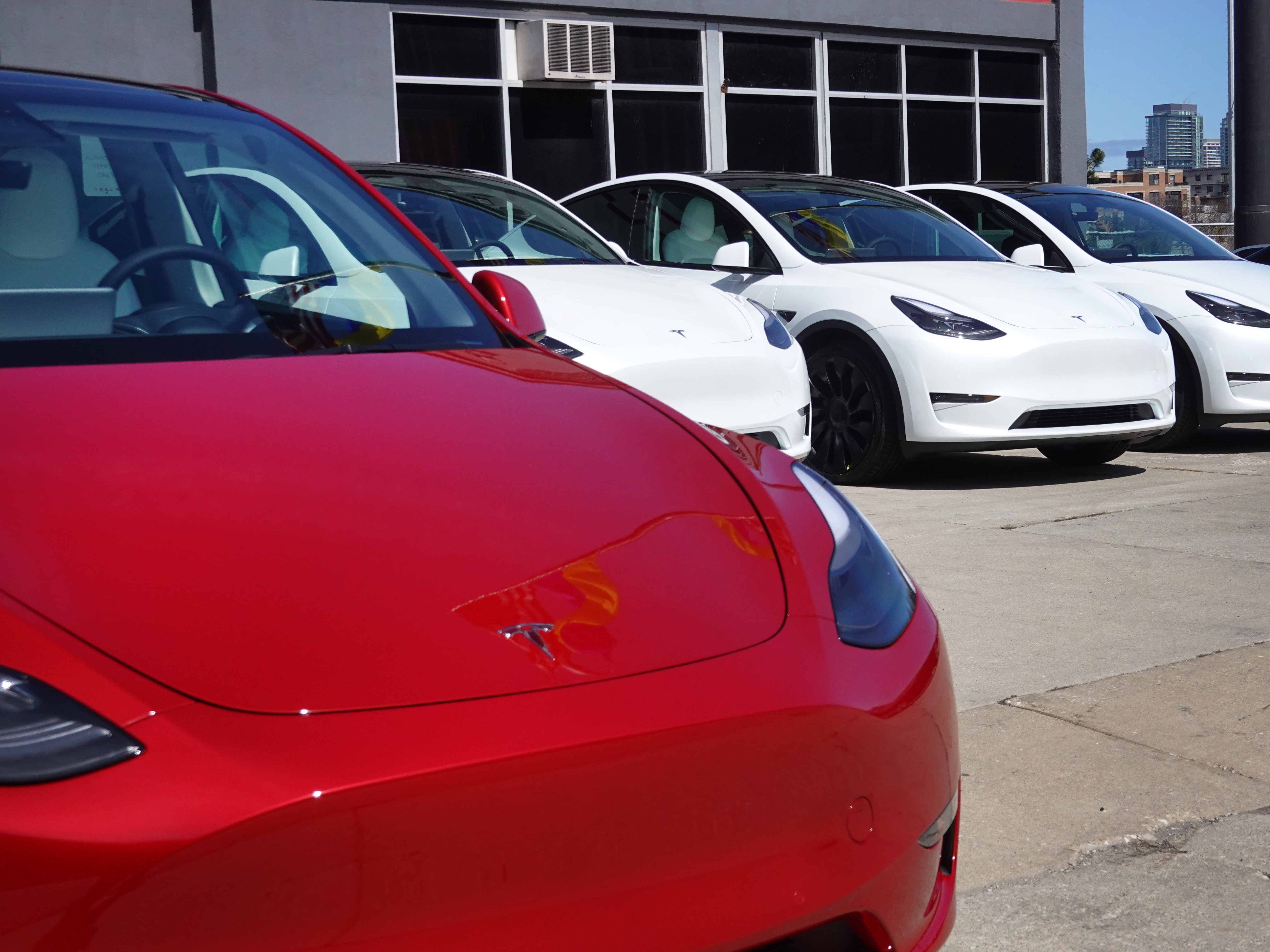 caption: Tesla cars sit on a lot in Chicago on March 28, 2022. A $7,500 tax credit for purchasers of new electric vehicles is changing again after the U.S. unveiled new guidelines that will impact the list of car models that qualify.