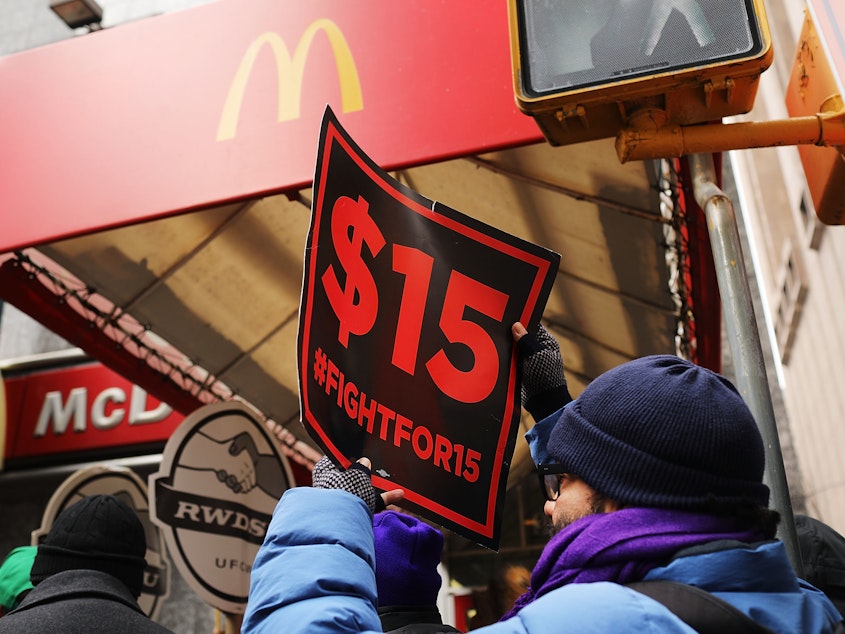 caption: Protesters with NYC Fight for $15 gather in front of a McDonalds to rally against fast food executive Andrew Puzder, who was President Trump's nominee to lead the Labor Department on February 13, 2017 in New York City.