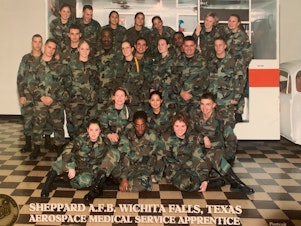 caption: Jessica Israelsen (first from the left in the second row from bottom) in 2003, when she first joined the U.S. Air Force as a medical technician. In 2008, when she was struggling financially, her unit purchased Christmas gifts for her family.