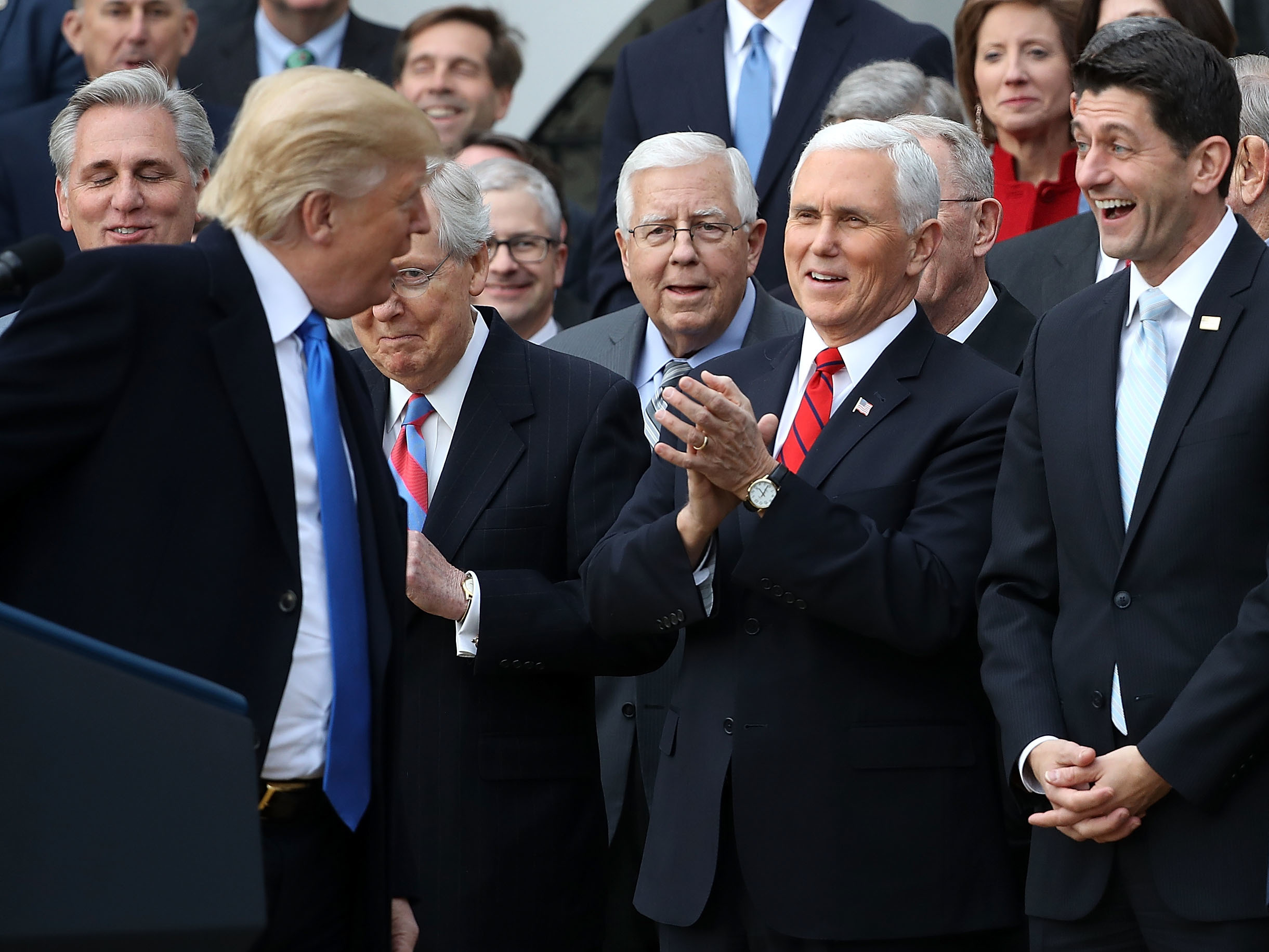 caption: Donald Trump celebrates the passage of the Tax Cuts and Jobs Act.