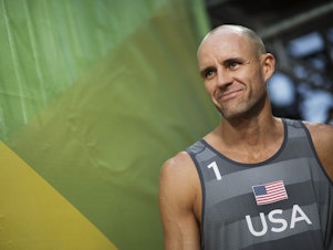 caption: U.S. beach volleyball player Jake Gibb, shown here in 2016, is continuing to compete in the Tokyo Olympics after his partner tested positive for the coronavirus.